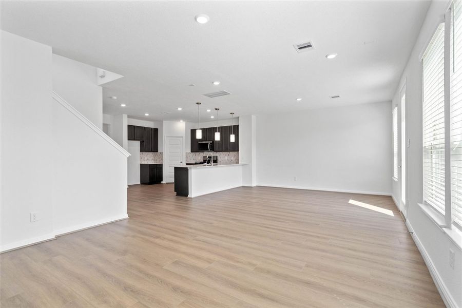 Open-concept design seamlessly connecting the living, dining, and kitchen areas—perfect for both everyday living and entertaining!