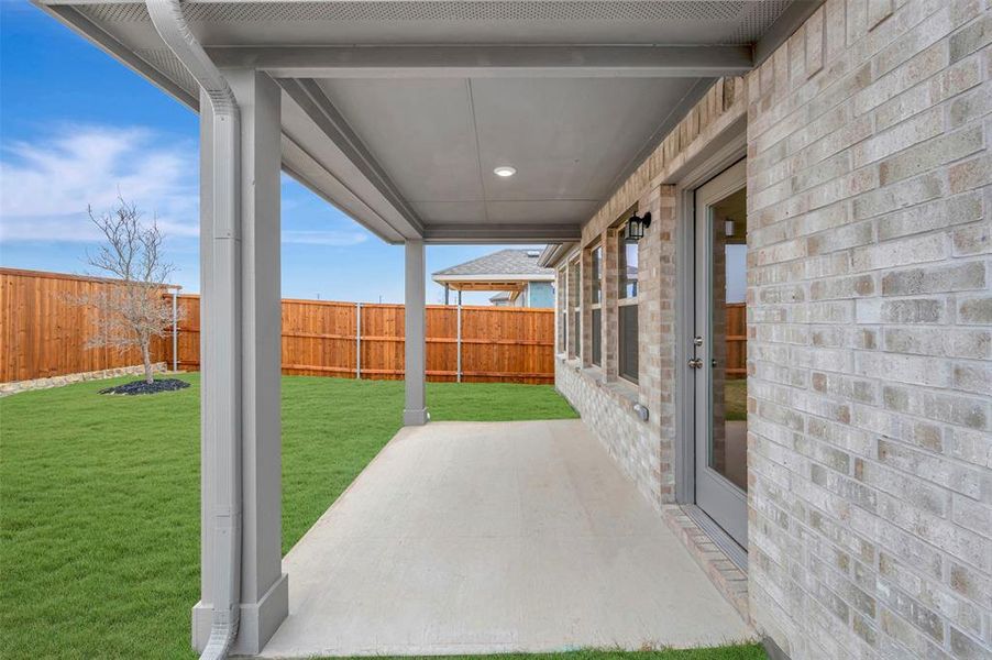 Exterior details and patio area of a home in Mobberly Farms, Pilot Point (Image 3).
