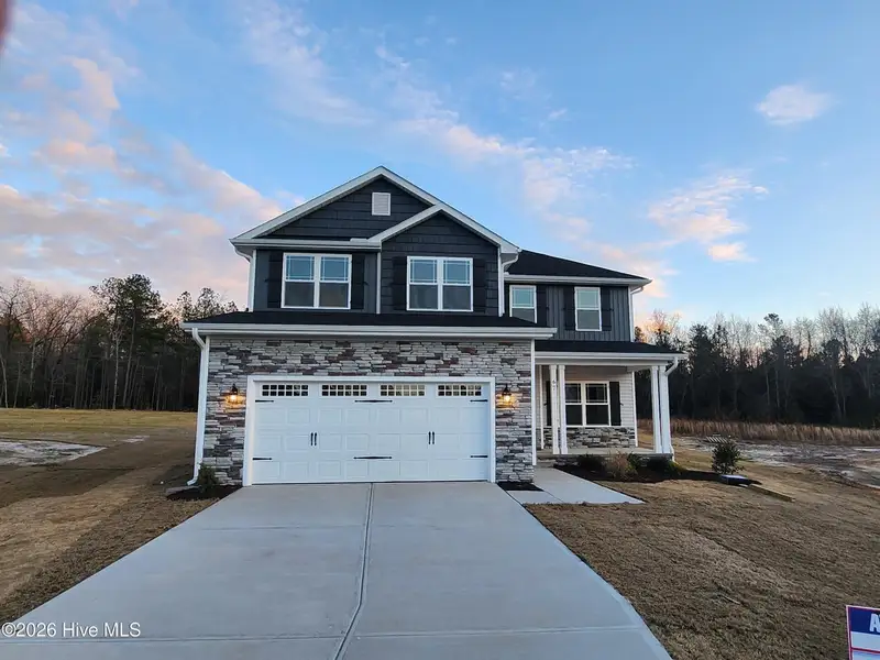 Front exterior of a new home in Patriot Pointe, Jacksonville, NC, highlighting curb appeal (Image 1). Front exterior of a new home in Patriot Pointe, Jacksonville, NC, highlighting curb appeal (Image 1).