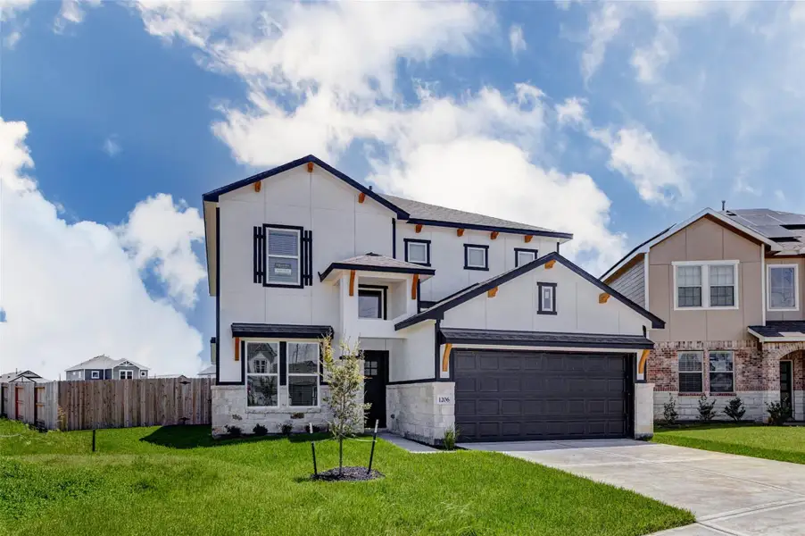 Beautiful front elevation with standout curb appeal, featuring a two-story design, black-framed windows, stone accents, decorative wood brackets, and a welcoming covered entry. The oversized driveway leads to an attached two-car garage, while the front lawn and young landscaping add a polished touch. The side fencing enhances privacy and hints at the spacious backyard beyond. Beautiful front elevation with standout curb appeal, featuring a two-story design, black-framed windows, stone accents, decorative wood brackets, and a welcoming covered entry. The oversized driveway leads to an attached two-car garage, while the front lawn and young landscaping add a polished touch. The side fencing enhances privacy and hints at the spacious backyard beyond.