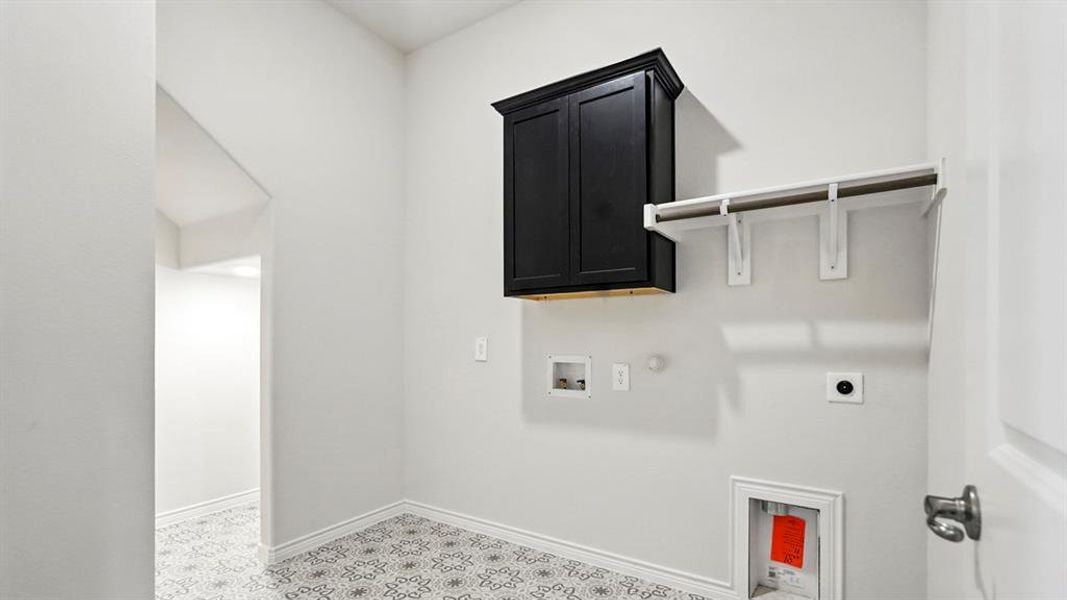 Laundry room featuring hookup for a gas dryer, hookup for an electric dryer, cabinet space, and washer hookup