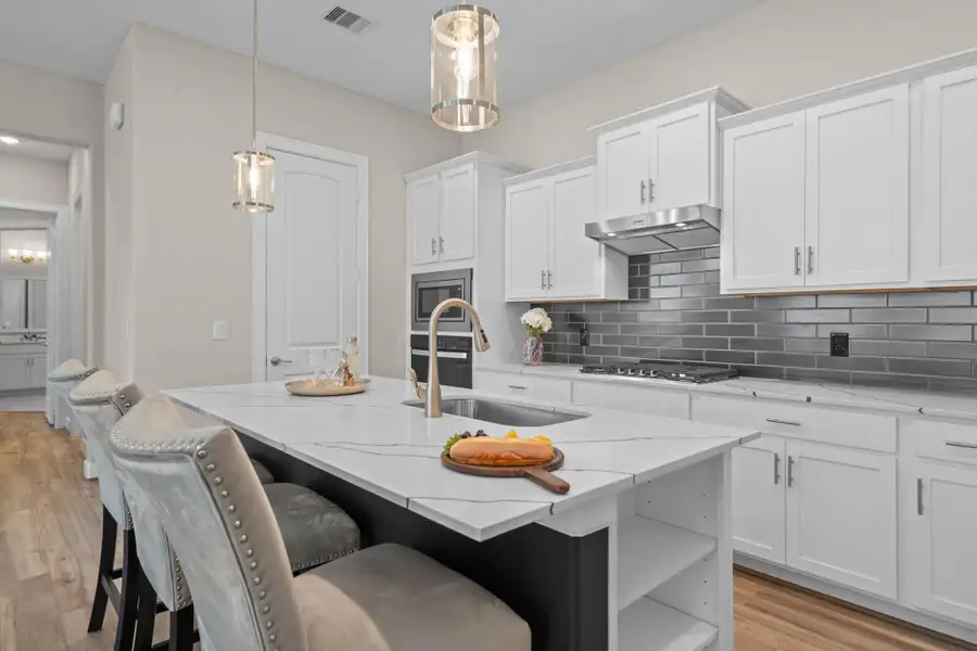 The Promenade III kitchen is designed for both style and functionality, featuring sleek countertops, ample cabinet space, and a convenient open layout that keeps you connected to the living and dining areas.
