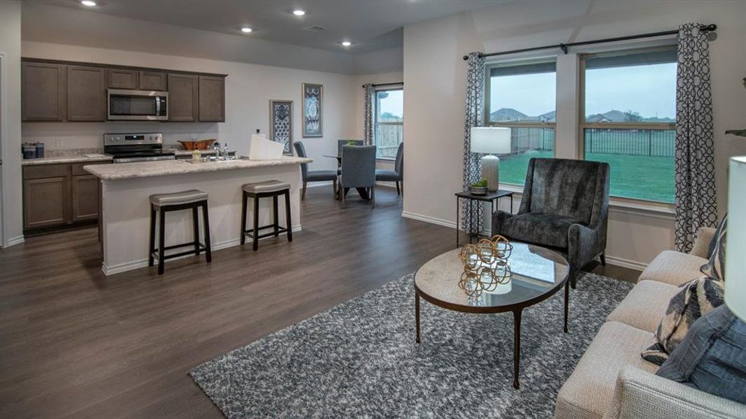 Living area featuring dark wood-style flooring and recessed lighting