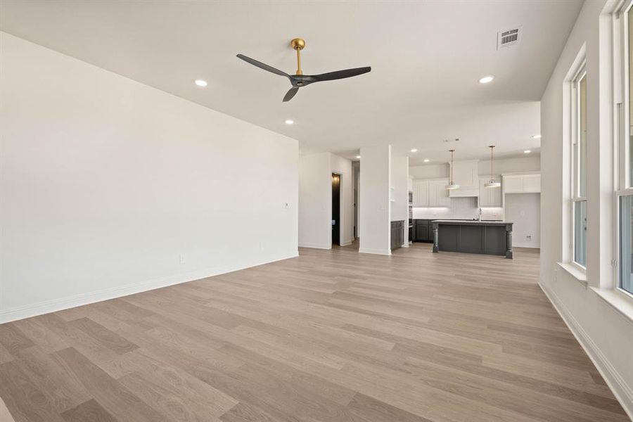 Unfurnished living room featuring recessed lighting, visible vents, and light wood finished floors