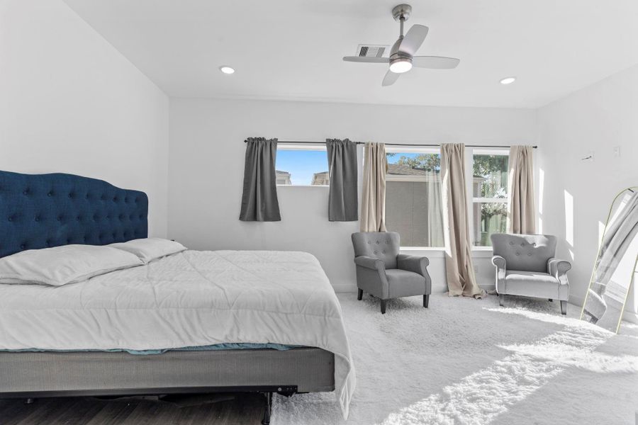 Relaxing primary retreat designed with open space and warmth.