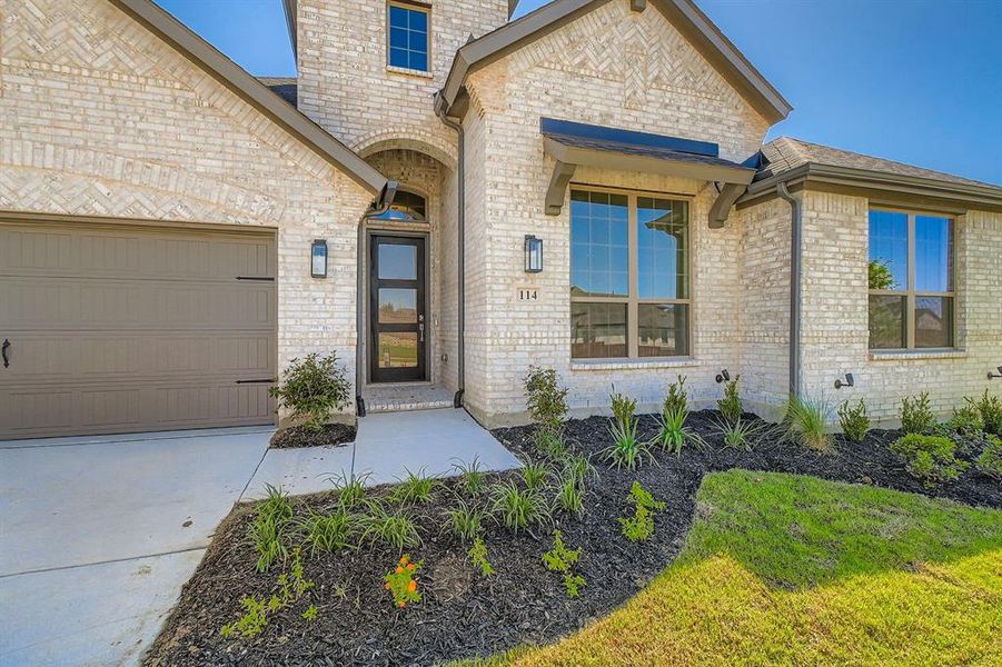 Front exterior of a new home in Reunion 70s, Rhome, TX, highlighting curb appeal (Image 2). Front exterior of a new home in Reunion 70s, Rhome, TX, highlighting curb appeal (Image 2).
