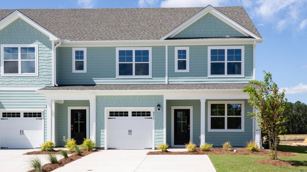 Front exterior of a new home in Indigo Preserve Townhomes, Leland, NC, highlighting curb appeal (Image 1).