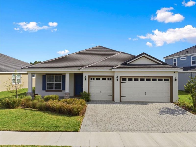 Front exterior of a new home in Tamarack at Two Rivers, Zephyrhills, FL, highlighting curb appeal (Image 32).