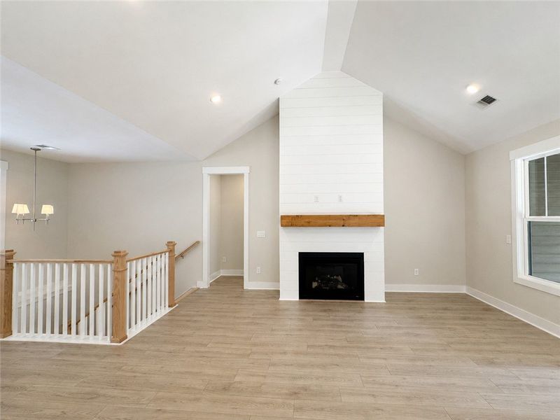 A spacious living area with vaulted ceilings and a