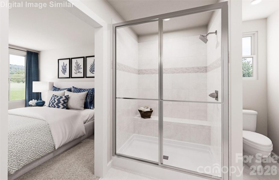 Rest easy in a primary suite designed for comfort, with a beautiful ensuite bath featuring a framed shower and convenient shower seat.