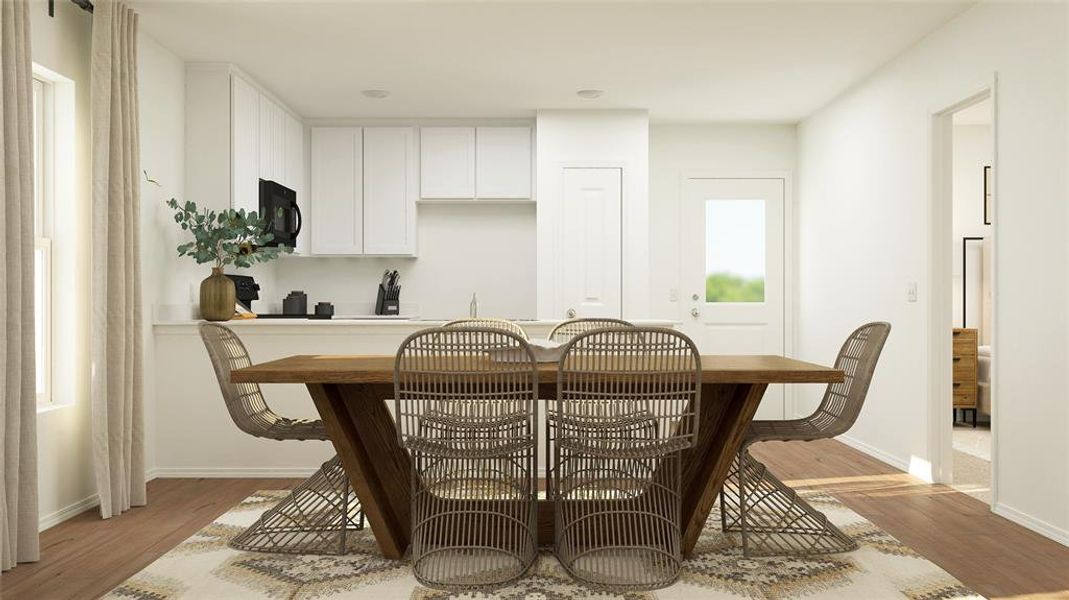 Dining area with light wood-type flooring