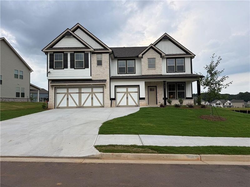 Front exterior of a new home in Grandview at Millers Mill, Stockbridge, GA, highlighting curb appeal (Image 2). Front exterior of a new home in Grandview at Millers Mill, Stockbridge, GA, highlighting curb appeal (Image 2).