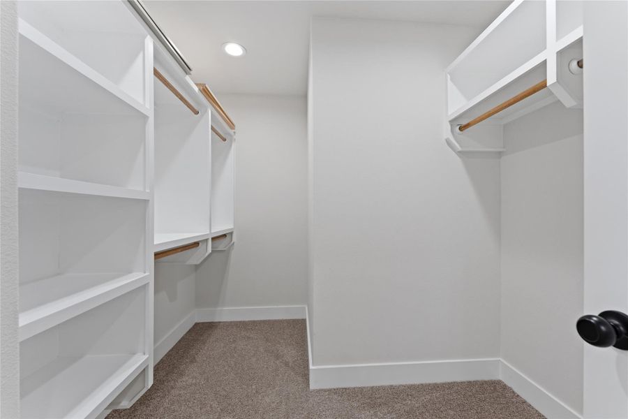 A spacious, thoughtfully designed walk-in closet with an efficient layout that makes it easy to organize clothing, shoes, and everyday essentials.