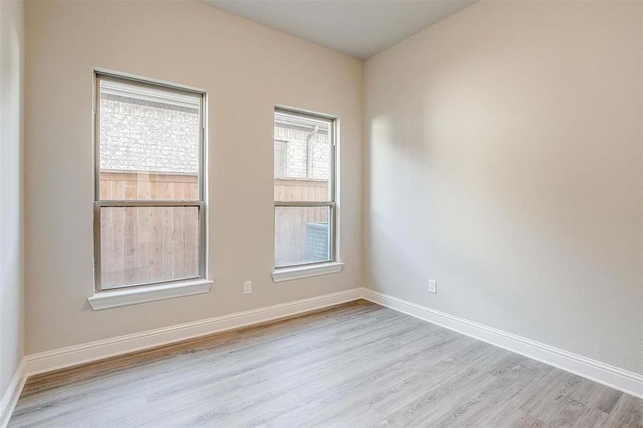 Empty room with light hardwood / wood-style flooring