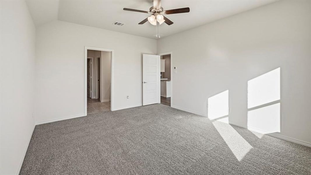 Unfurnished bedroom featuring carpet and ceiling fan Unfurnished bedroom featuring carpet and ceiling fan