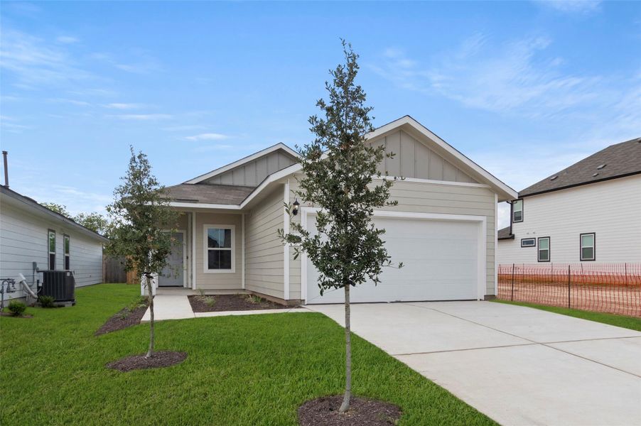 View of front of property featuring board and batten siding, an attached garage, and concrete driveway View of front of property featuring board and batten siding, an attached garage, and concrete driveway