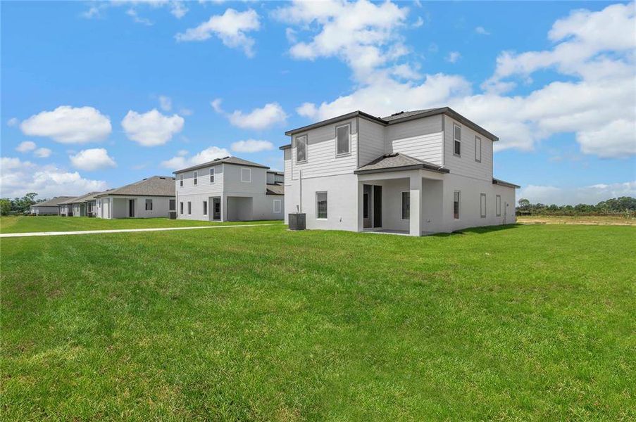 Front exterior of a new home in Gum Lake Preserve, Lake Alfred, FL, highlighting curb appeal (Image 1).
