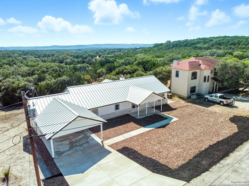 Front exterior of a new home in , Lakehills, TX, highlighting curb appeal (Image 19).