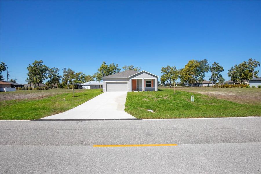 Front exterior of a new home in Burnt Store Village, Punta Gorda, FL, highlighting curb appeal (Image 14).