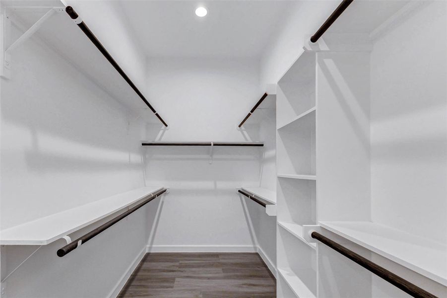 A true walk-in dream closet with double hanging rods, open shelving, and built-in organization. Clean lines and generous dimensions ensure everything has its place. A true walk-in dream closet with double hanging rods, open shelving, and built-in organization. Clean lines and generous dimensions ensure everything has its place.