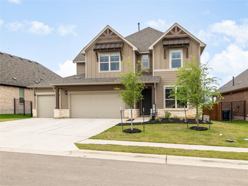 Front exterior of a new home in Saddleback at Santa Rita Ranch, Liberty Hill, TX, highlighting curb appeal (Image 1). Front exterior of a new home in Saddleback at Santa Rita Ranch, Liberty Hill, TX, highlighting curb appeal (Image 1).