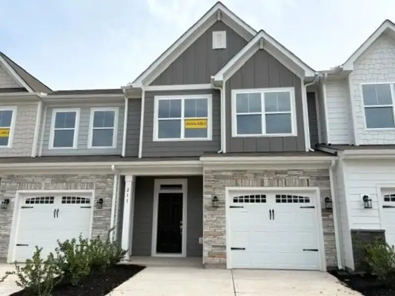 Front exterior of a new home in Riverbrooke Townhomes, Simpsonville, SC, highlighting curb appeal (Image 1). Front exterior of a new home in Riverbrooke Townhomes, Simpsonville, SC, highlighting curb appeal (Image 1).