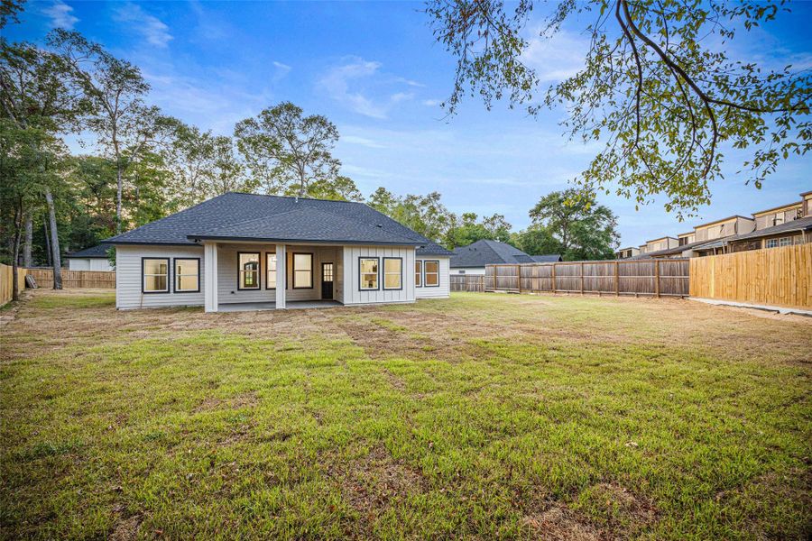Front exterior of a new home in , Conroe, TX, highlighting curb appeal (Image 1).