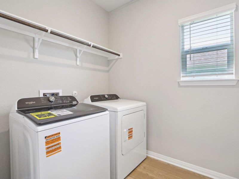 Laundry room featuring separate washer and dryer, light wood-style floors, and baseboards Laundry room featuring separate washer and dryer, light wood-style floors, and baseboards