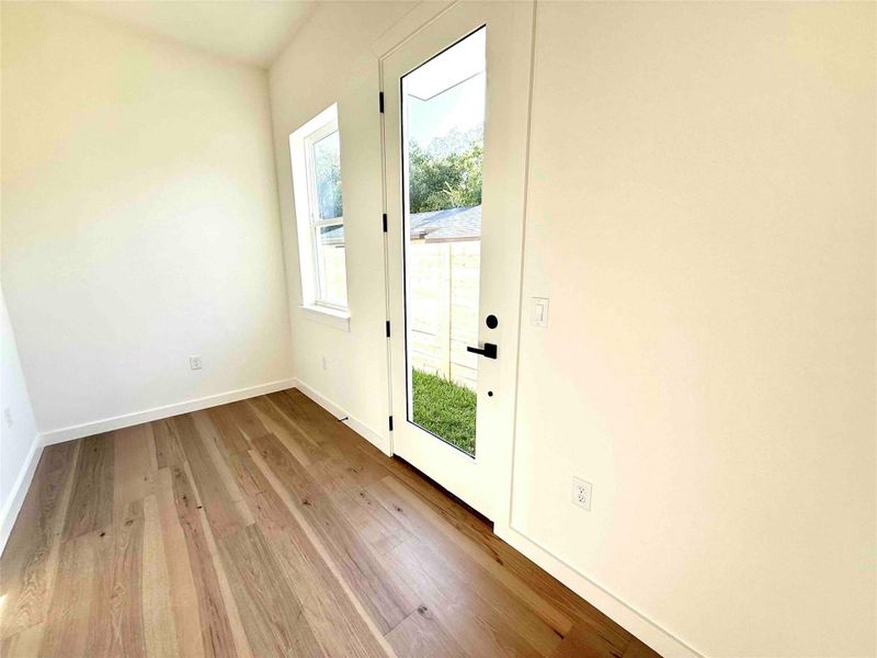 Doorway to outside with hardwood / wood-style floors and baseboards