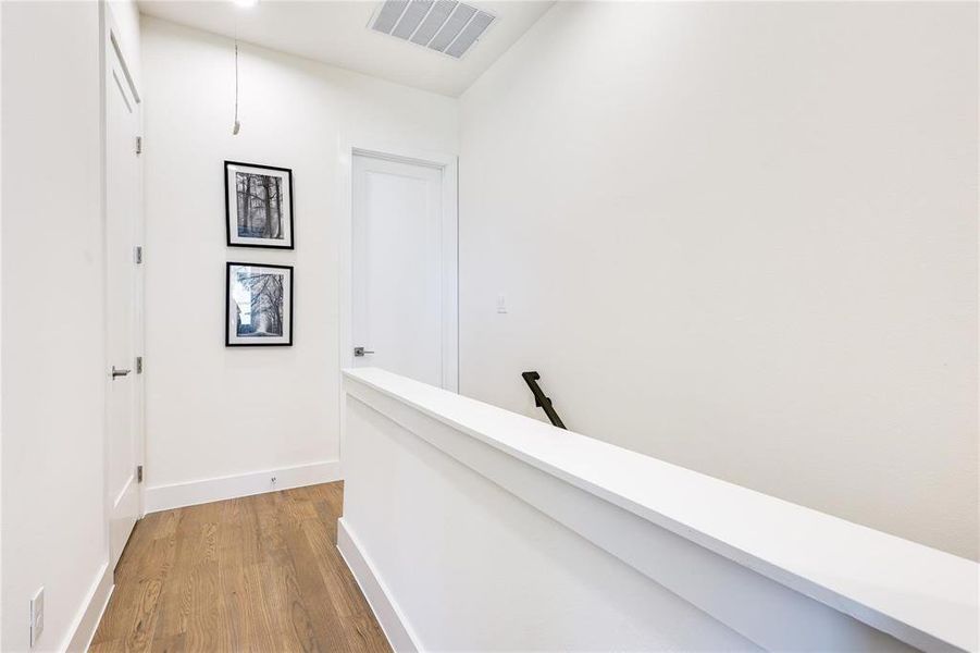 Hall with light hardwood / wood-style floors