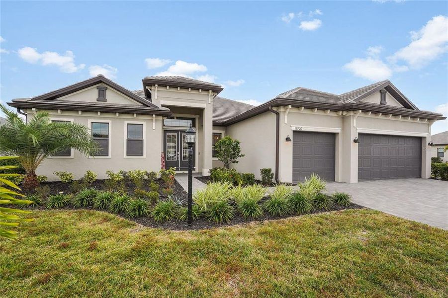 Front exterior of a new home in , Lakewood Ranch, FL, highlighting curb appeal (Image 1). Front exterior of a new home in , Lakewood Ranch, FL, highlighting curb appeal (Image 1).