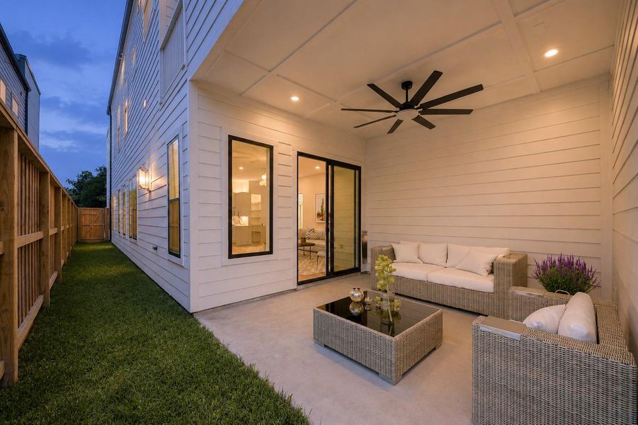 The covered patio extends directly off the main living spaces, creating an outdoor area that feels connected to the home rather than separate from it. Covered seating space and surrounding green space make the area functional for everyday use or entertaining. (digitally staged) The covered patio extends directly off the main living spaces, creating an outdoor area that feels connected to the home rather than separate from it. Covered seating space and surrounding green space make the area functional for everyday use or entertaining. (digitally staged)