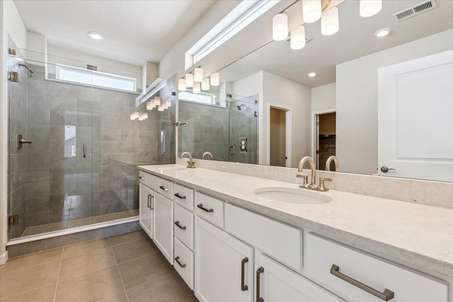 A bathroom with a large mirror.