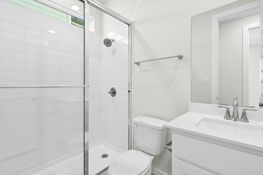 Full bath with vanity and a shower stall