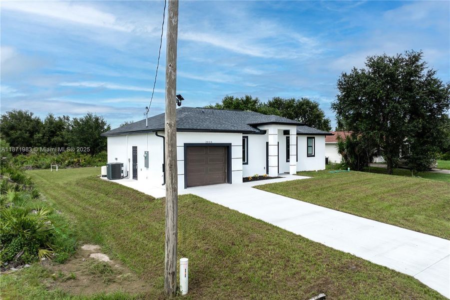 Front exterior of a new home in , Lehigh Acres, FL, highlighting curb appeal (Image 18).