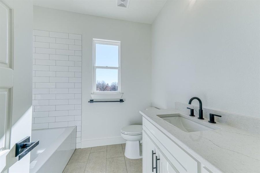 Tiled tub/shower combo in the 2nd hall bath.