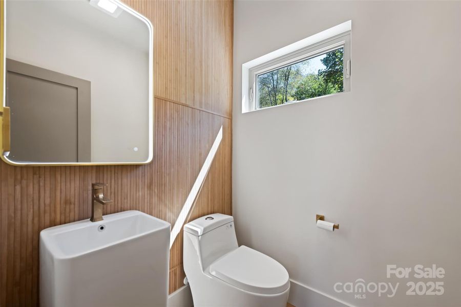 Half bath in great room is conveniently located near entry for guest comfort and owner livability.