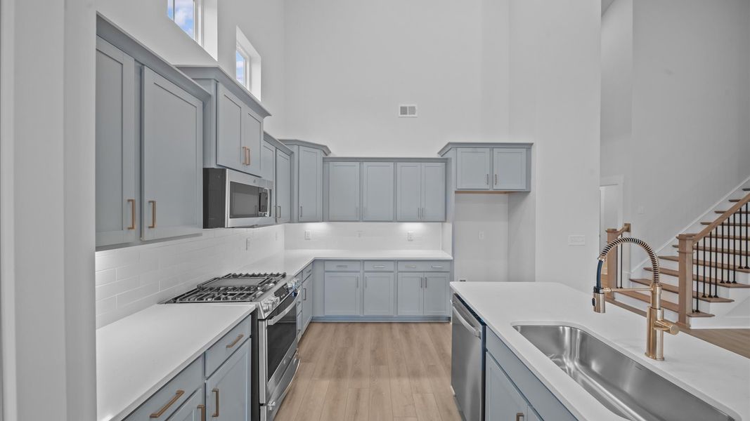 Elegant kitchen featuring an 8-foot island with a tasteful finishes throughout Elegant kitchen featuring an 8-foot island with a tasteful finishes throughout