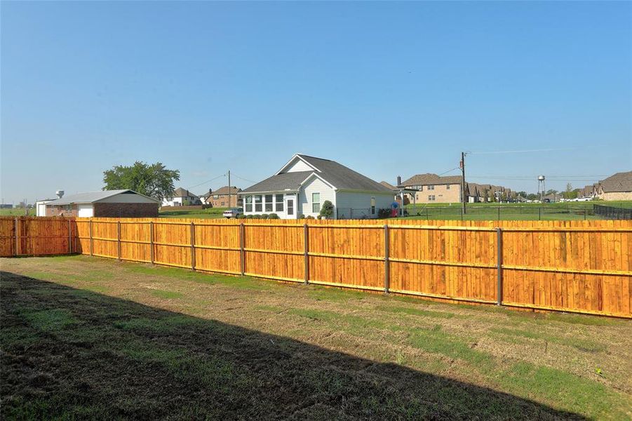 Fenced backyard with a residential view