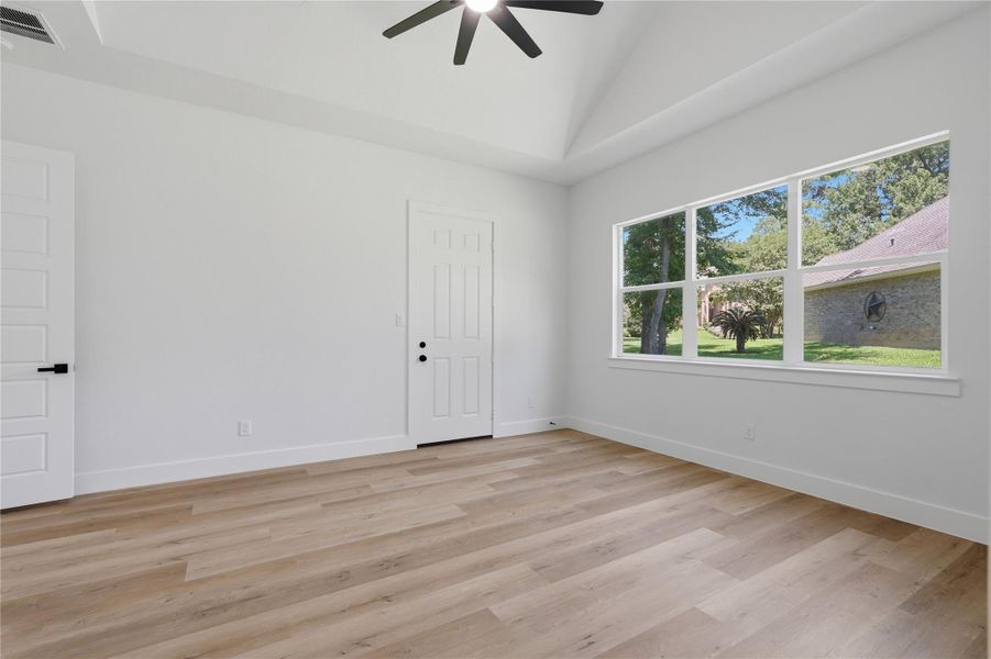 master retreat on first floor has LVP wide plank flooring, ceiling fans, picture windows and an exterior door to the patio master retreat on first floor has LVP wide plank flooring, ceiling fans, picture windows and an exterior door to the patio