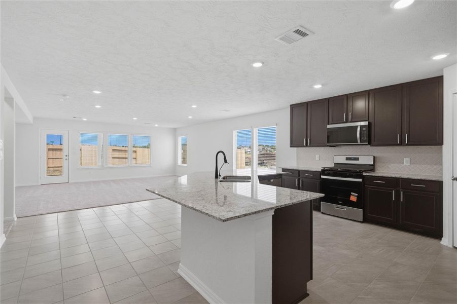 This expansive kitchen island is perfect for meal prep and a spacious breakfast bar for casual dining.