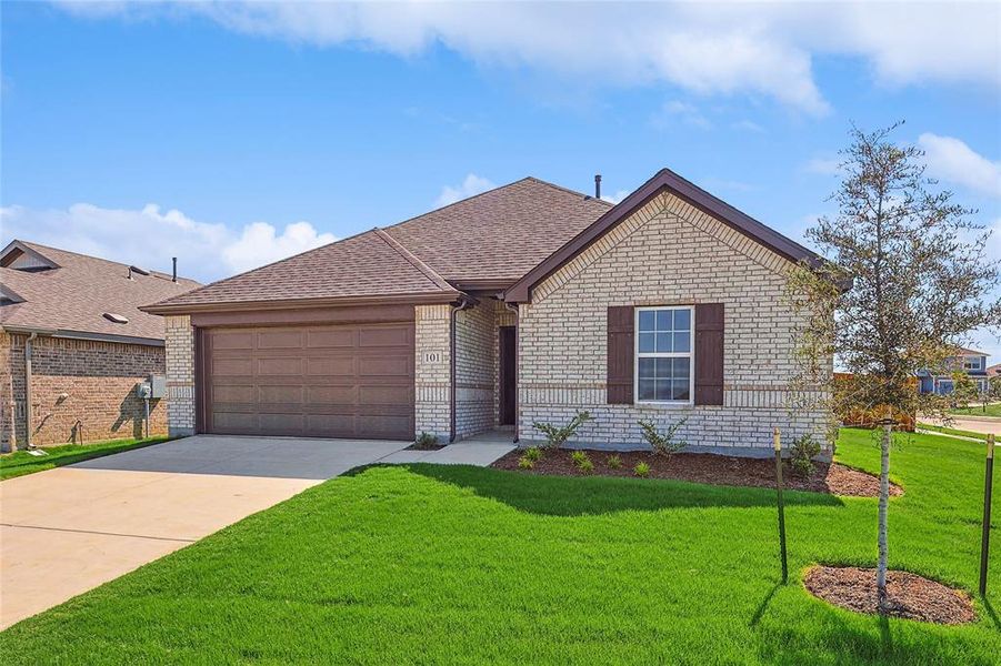 View of front facade featuring a front yard and a garage