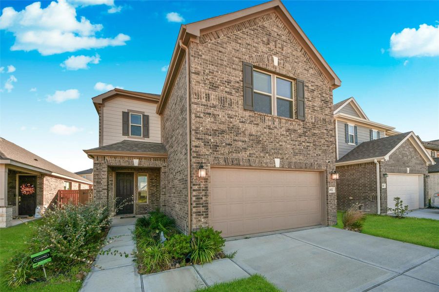Front exterior of a new home in Sunterra North, Katy, TX, highlighting curb appeal (Image 23).