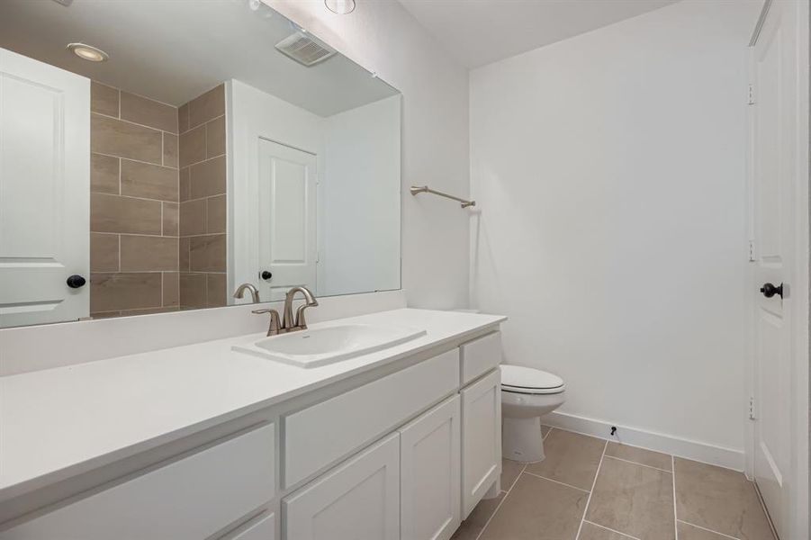 Bathroom featuring vanity and light tile patterned floors Bathroom featuring vanity and light tile patterned floors