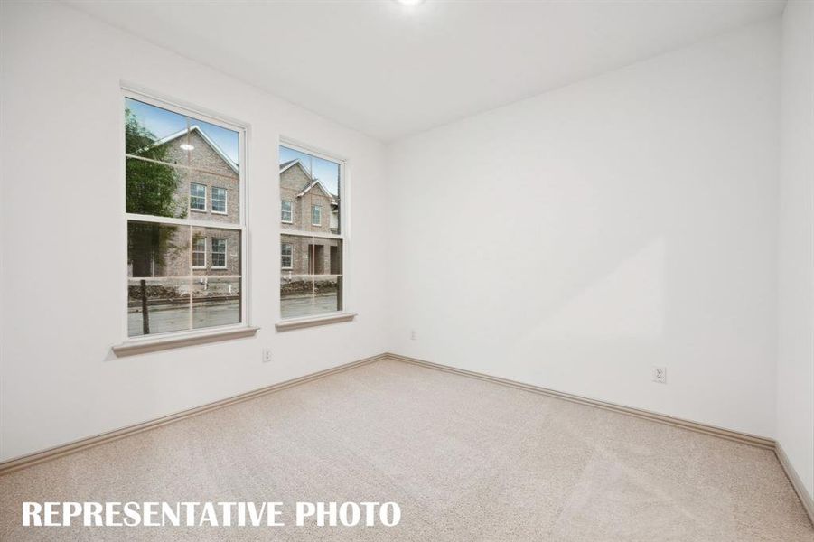 Your guests will enjoy their own space in this private, main floor secondary bedroom.  REPRESENTATIVE PHOTO