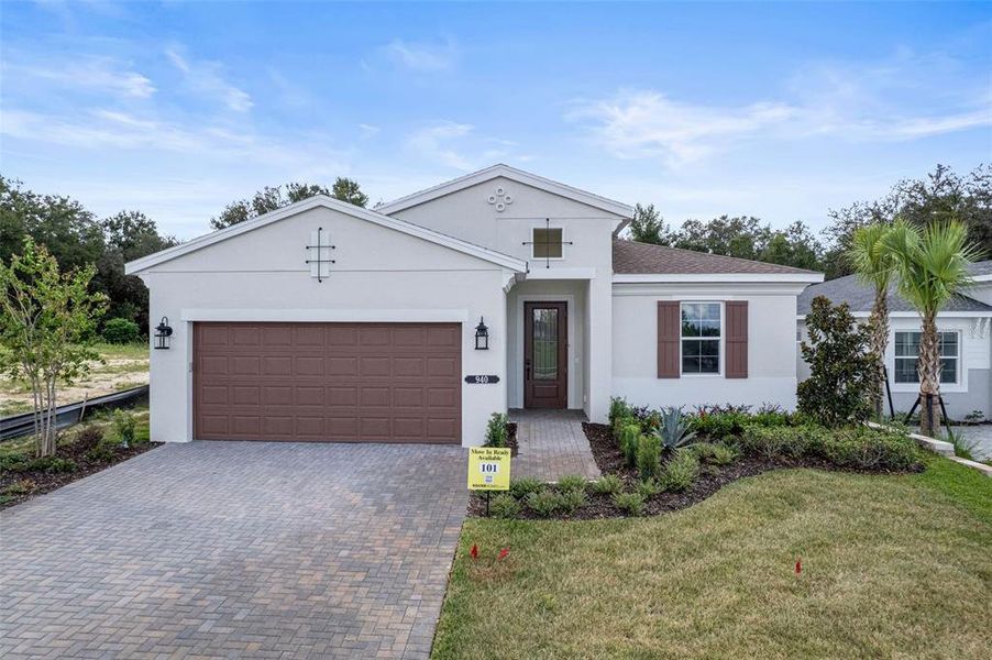 Front exterior of a new home in Cresswind at Hammock Oaks, Lady Lake, FL, highlighting curb appeal (Image 19). Front exterior of a new home in Cresswind at Hammock Oaks, Lady Lake, FL, highlighting curb appeal (Image 19).