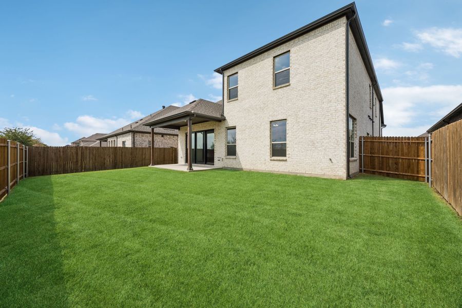 Exterior details and patio area of a home in Country Lakes, Denton (Image 22).