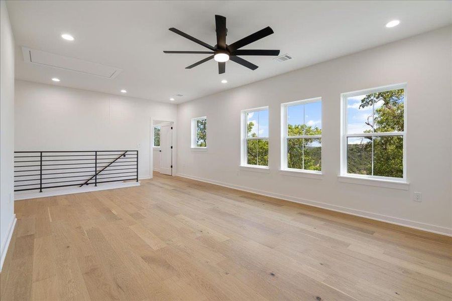 Empty room featuring recessed lighting, light wood-style floors, and a ceiling fan