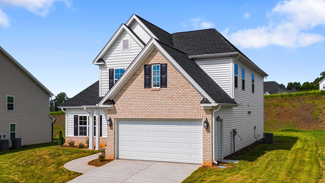 Front exterior of a new home in Brooke Hill, Lewisville, NC, highlighting curb appeal (Image 26). Front exterior of a new home in Brooke Hill, Lewisville, NC, highlighting curb appeal (Image 26).