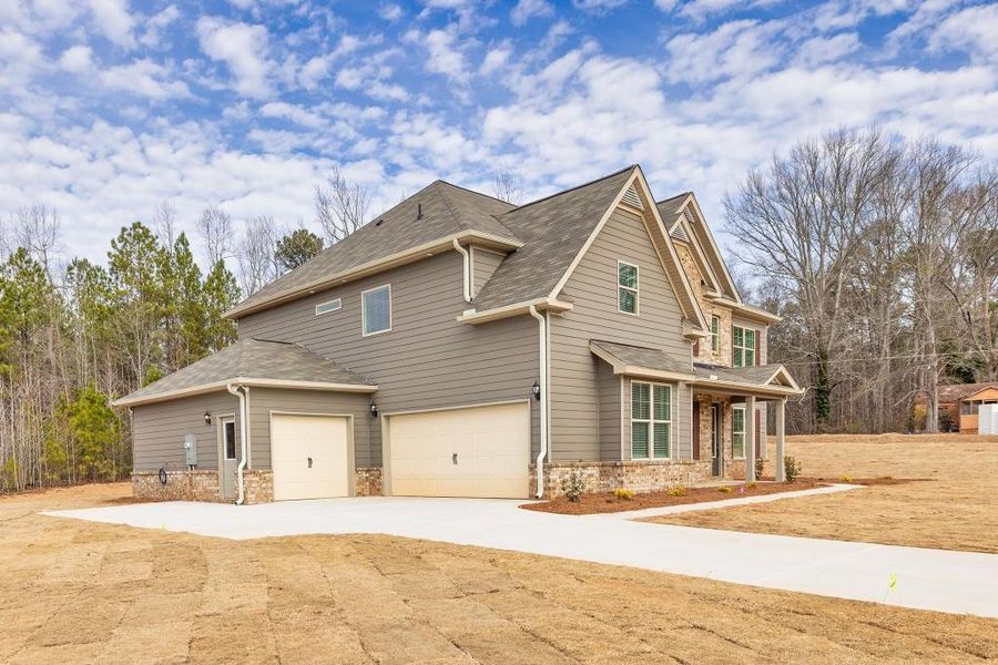 Front exterior of a new home in Ruby Creek Estates, Atlanta, GA, highlighting curb appeal (Image 25). Front exterior of a new home in Ruby Creek Estates, Atlanta, GA, highlighting curb appeal (Image 25).